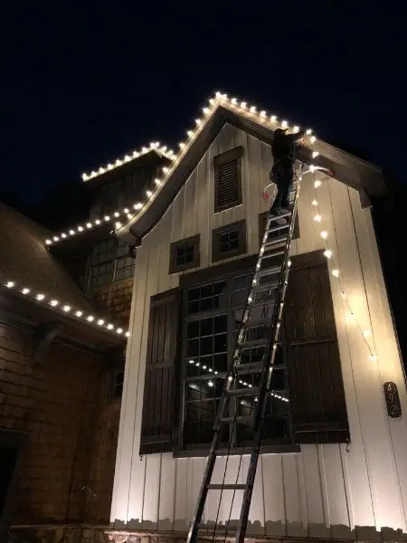 Using Ladder to hang Christmas Lights in DFW