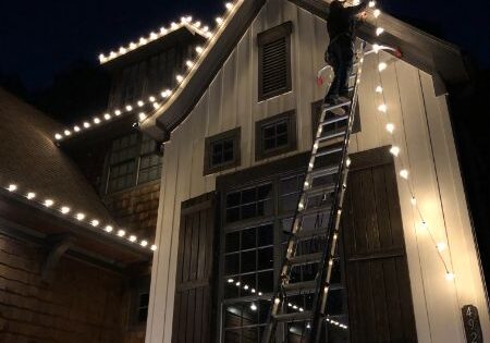 Using Ladder to hang Christmas Lights in DFW